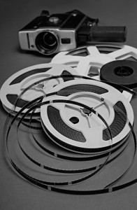 Still life of 8mm cine film reels and old movie camera.